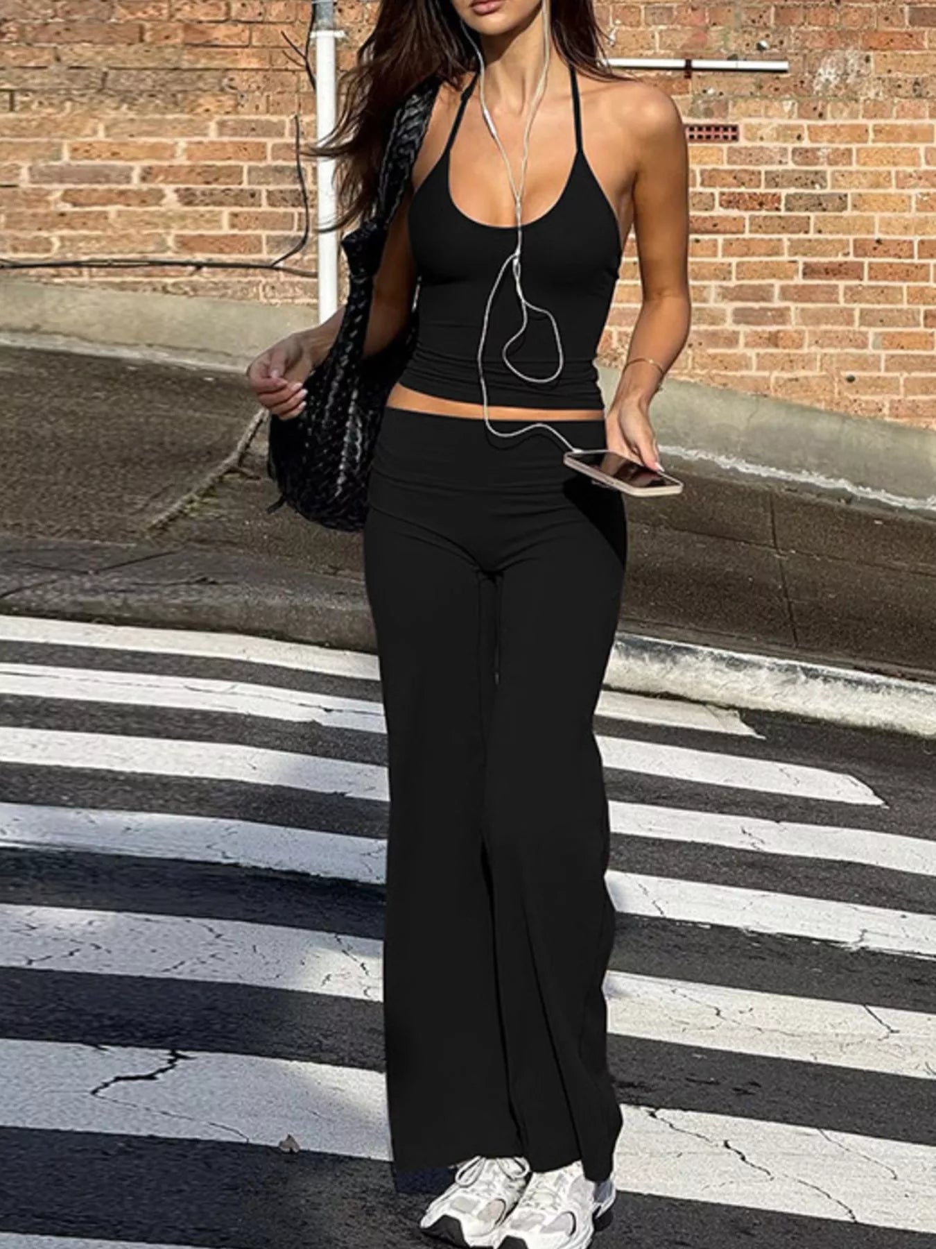 Black halter neck crop top and high-rise wide-leg pants set
