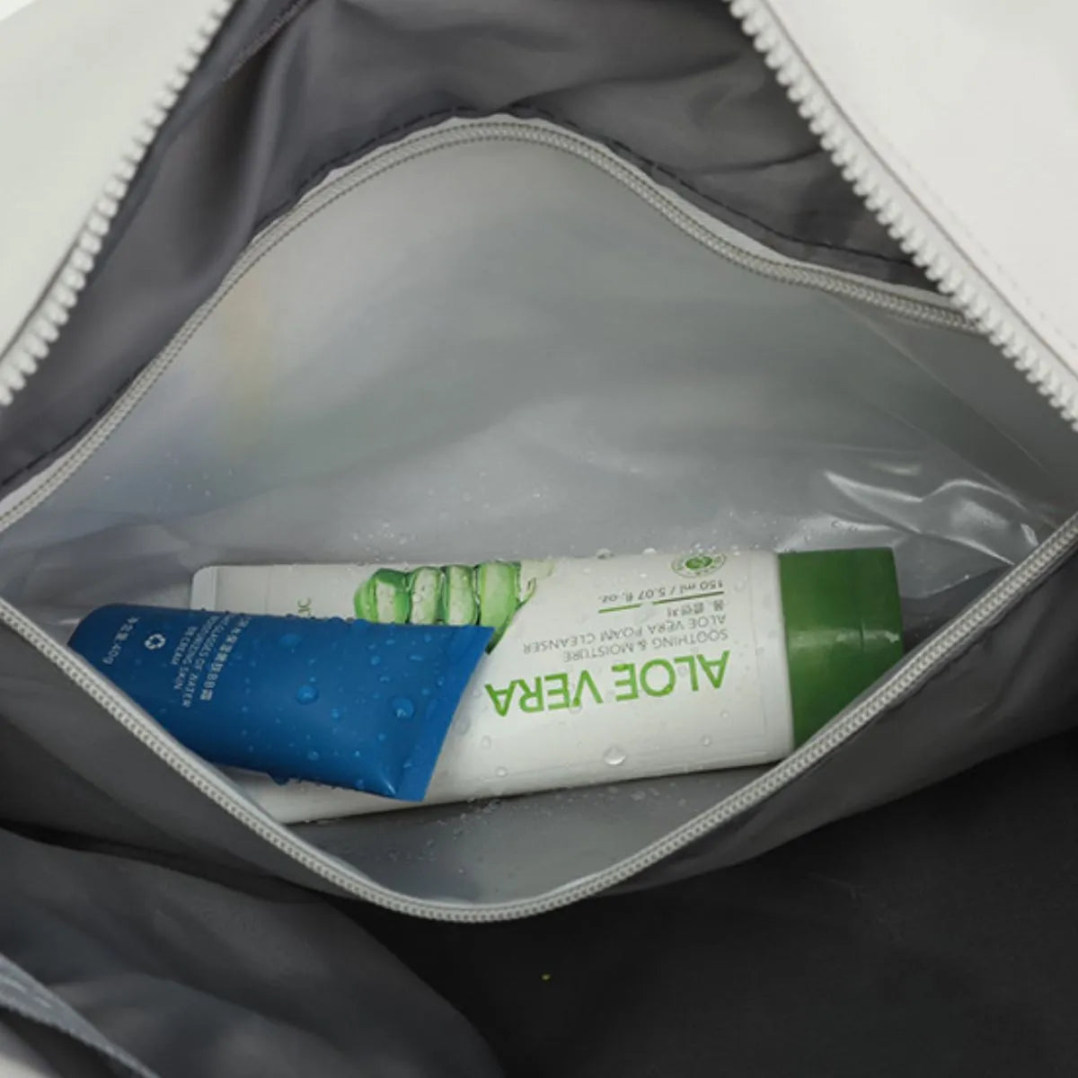 Nylon duffle bag interior with toiletries pouch and Aloe Vera tube