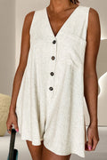 Light beige sleeveless V-neck romper with button-front and short rounded hem