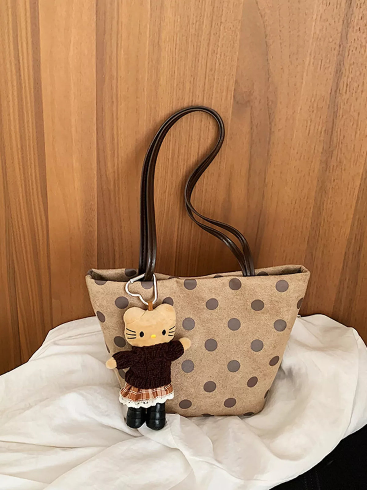 Tan suede tote handbag with dark polka dots and cat charm keychain