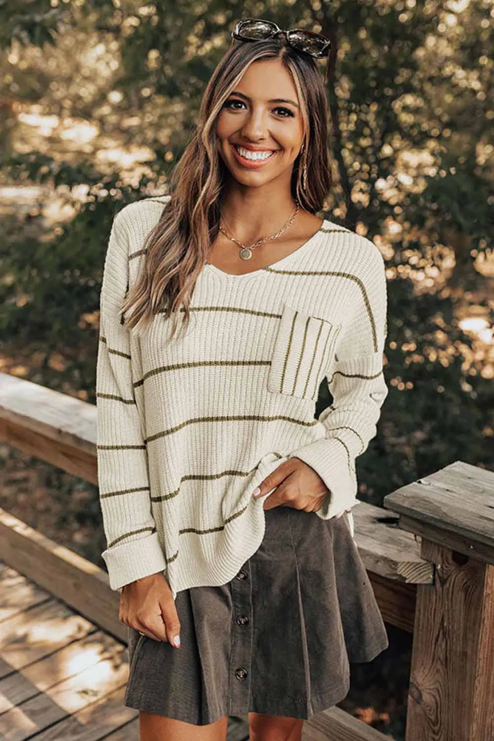 White striped V-neck drop-shoulder sweater with long sleeves and ribbed hem