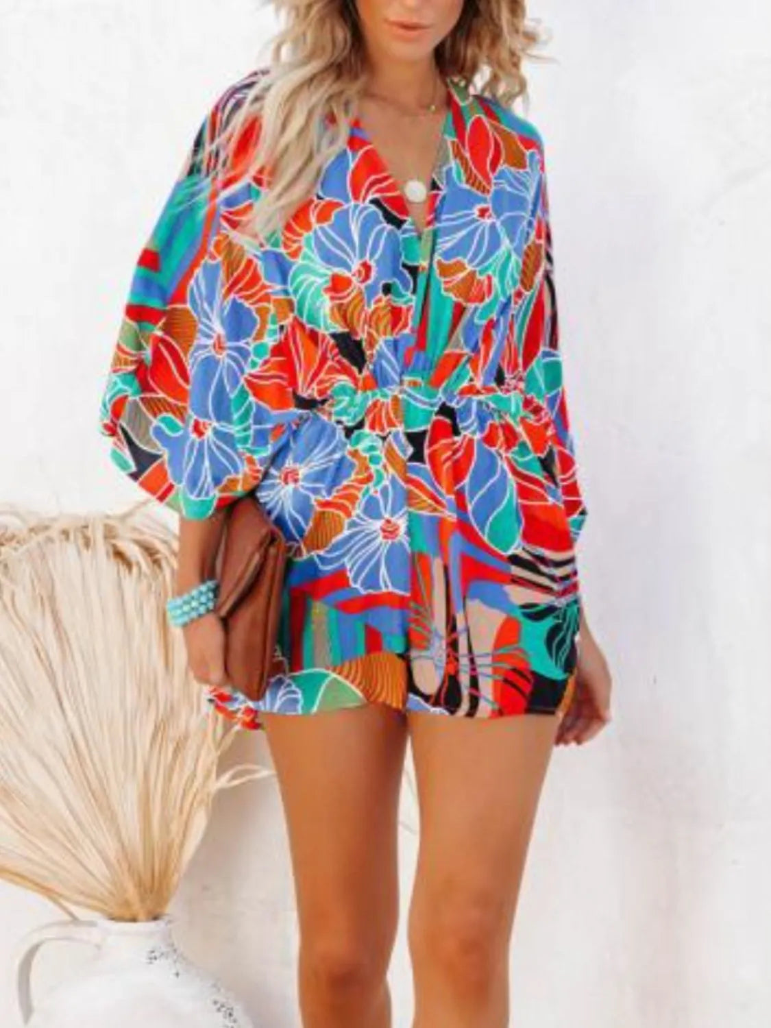 Floral printed romper with V-neck, elastic waist, and loose half sleeves