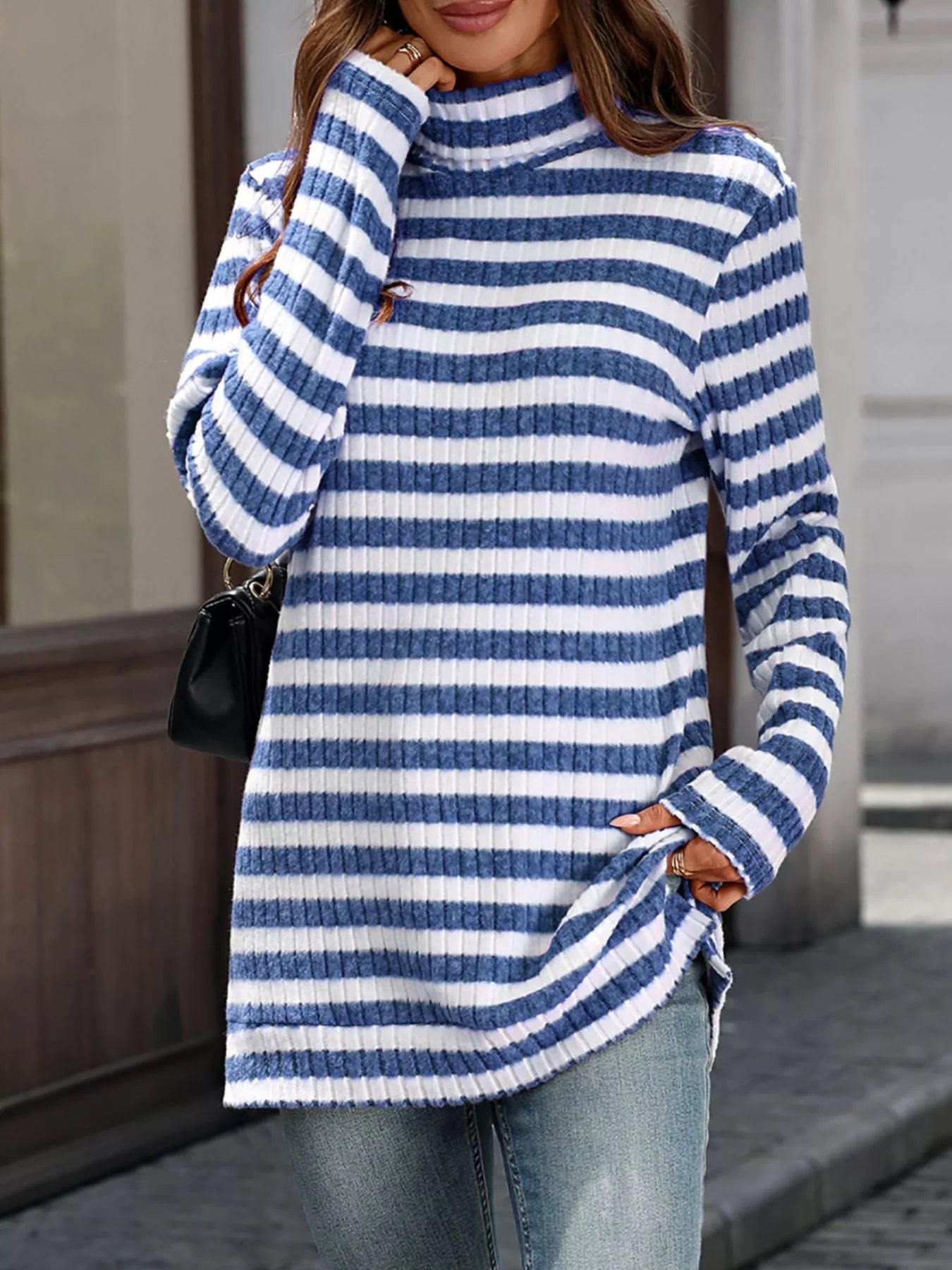 Blue and white striped knit turtleneck long-sleeve top with ribbed collar and cuffs.