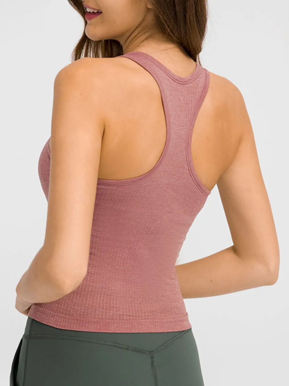 Dusty pink racerback active tank top with open back and curved armhole seams.