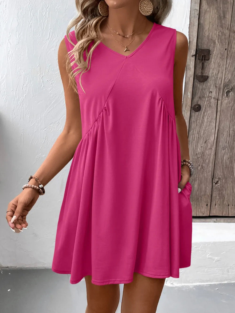 Ivy Lane Ruched V-Neck Sleeveless Mini Dress in hot pink.