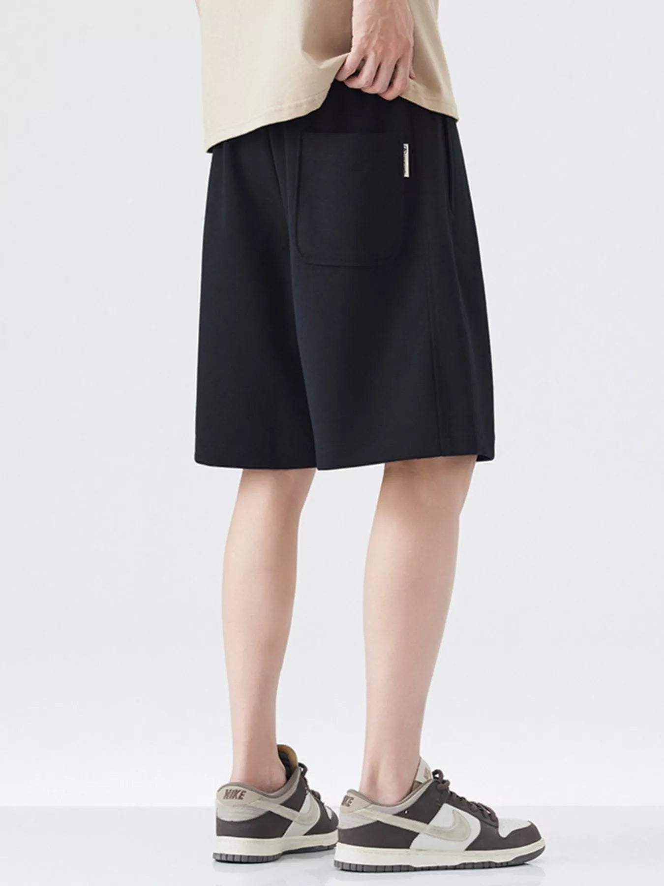 Black drawstring loose-fit shorts with front pocket and relaxed straight leg