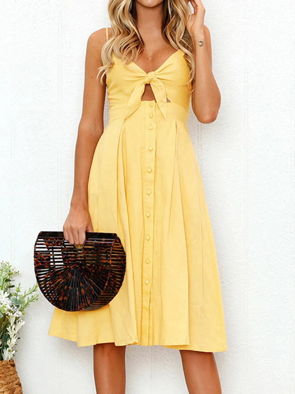 Yellow cami dress with sweetheart neckline, bow cutout bodice, button front, flared skirt