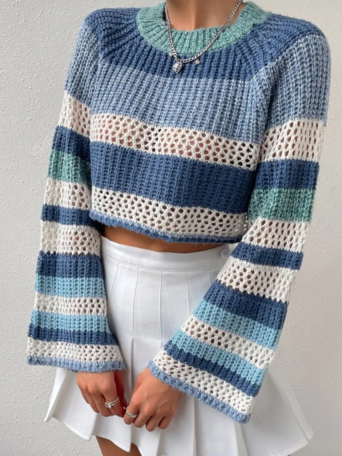 Striped color block crop sweater with openwork knit, ribbed trim, and crew neck