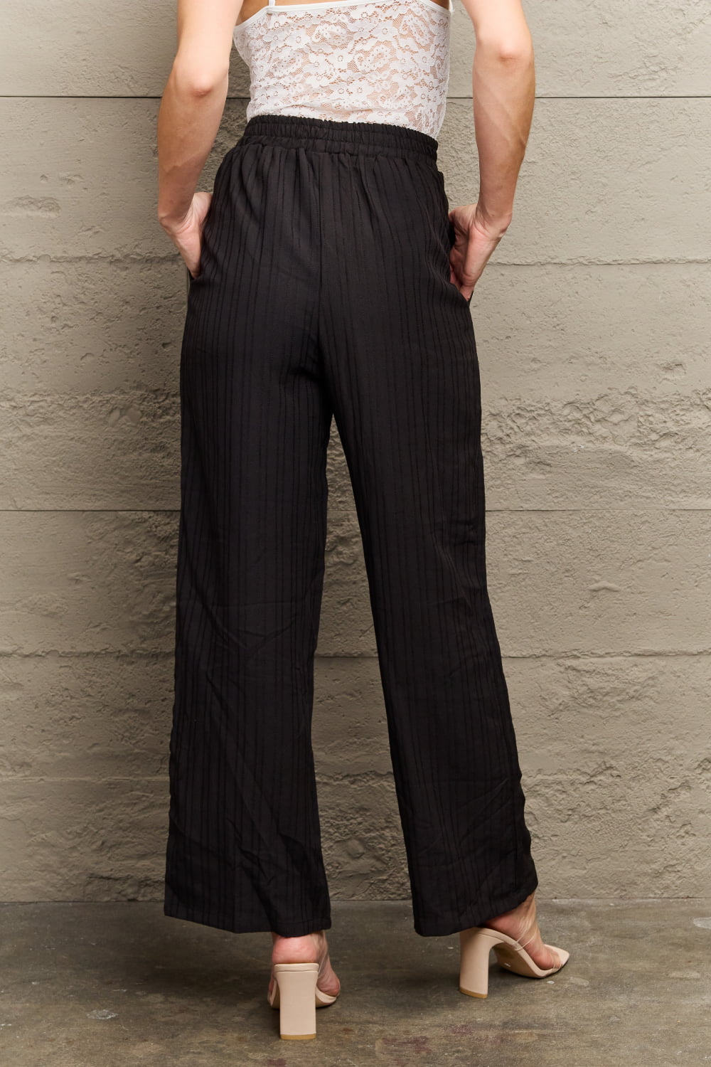 Black tie-waist long pants with elastic waist, pleated front, wide straight legs
