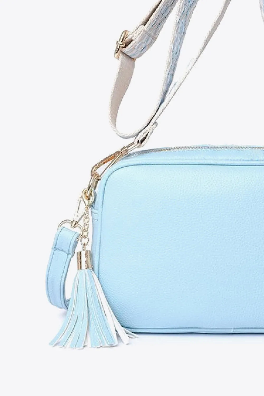 PU leather tassel crossbody bag, light blue side view with tassel charm