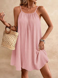 Cedar & Moore: Pink casual loose spaghetti-strap mini dress in textured fabric with a woven straw bag.