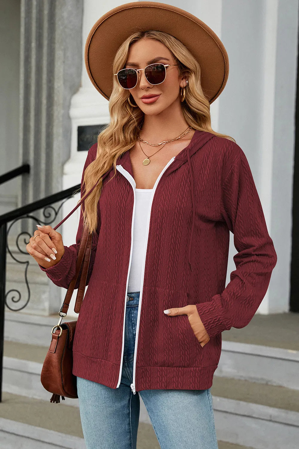 Burgundy zip-up hoodie with drawstring hood, long sleeves, and front pockets