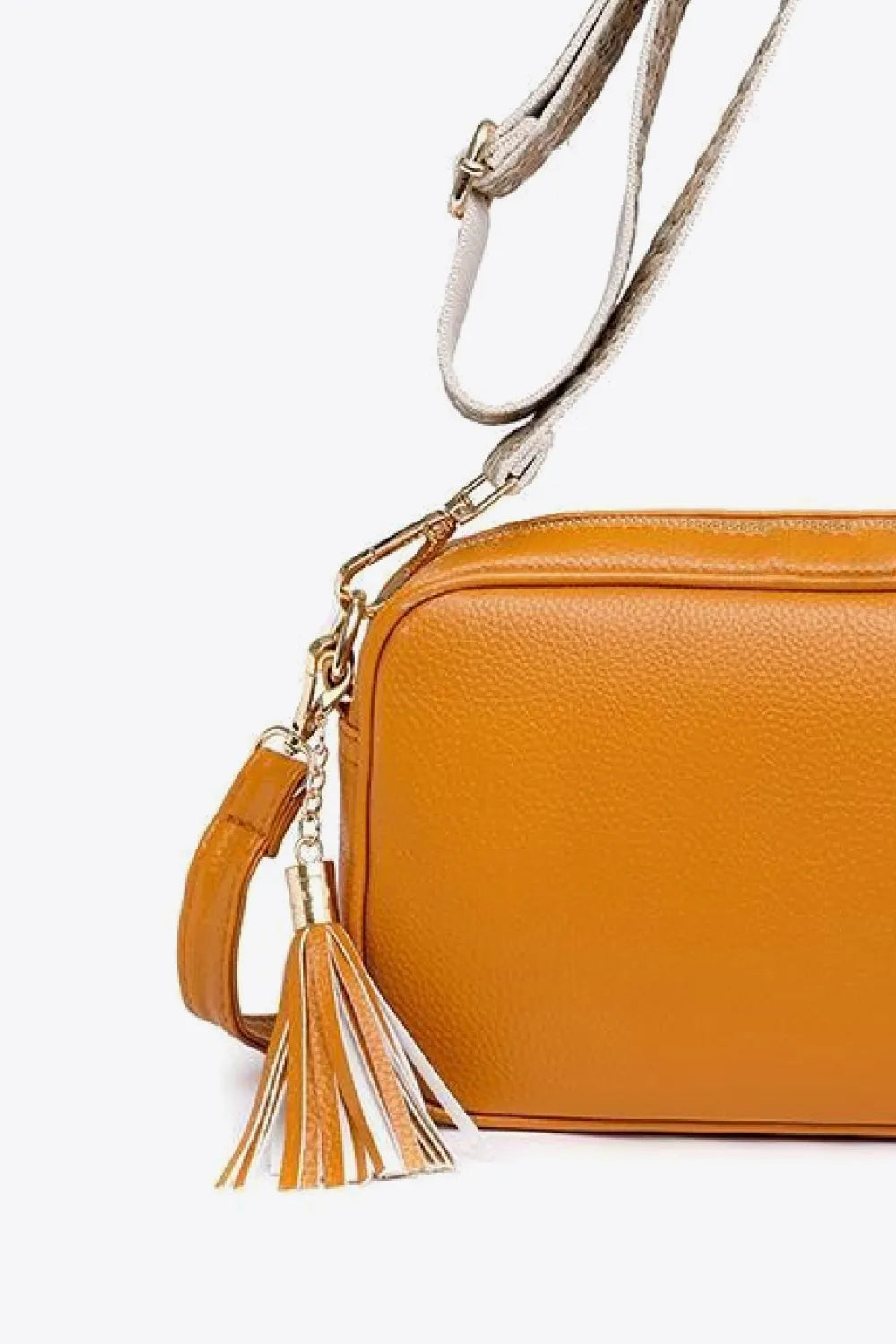 PU leather tassel crossbody bag, orange side close-up with tassel zipper pull and strap