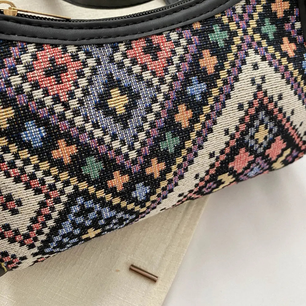 Close-up of geometric woven crossbody fabric, cream base with multicolor cross motifs