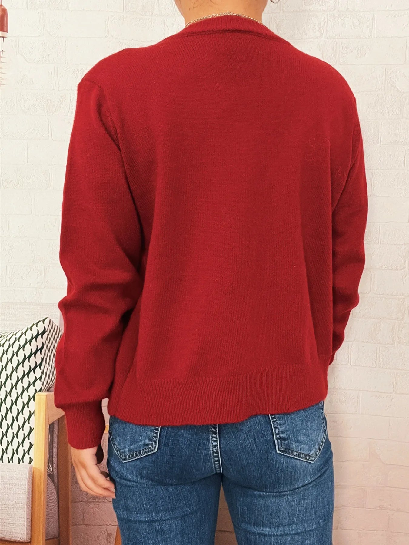 Red button-up long sleeve cardigan with knit fabric, ribbed hem, and button front.