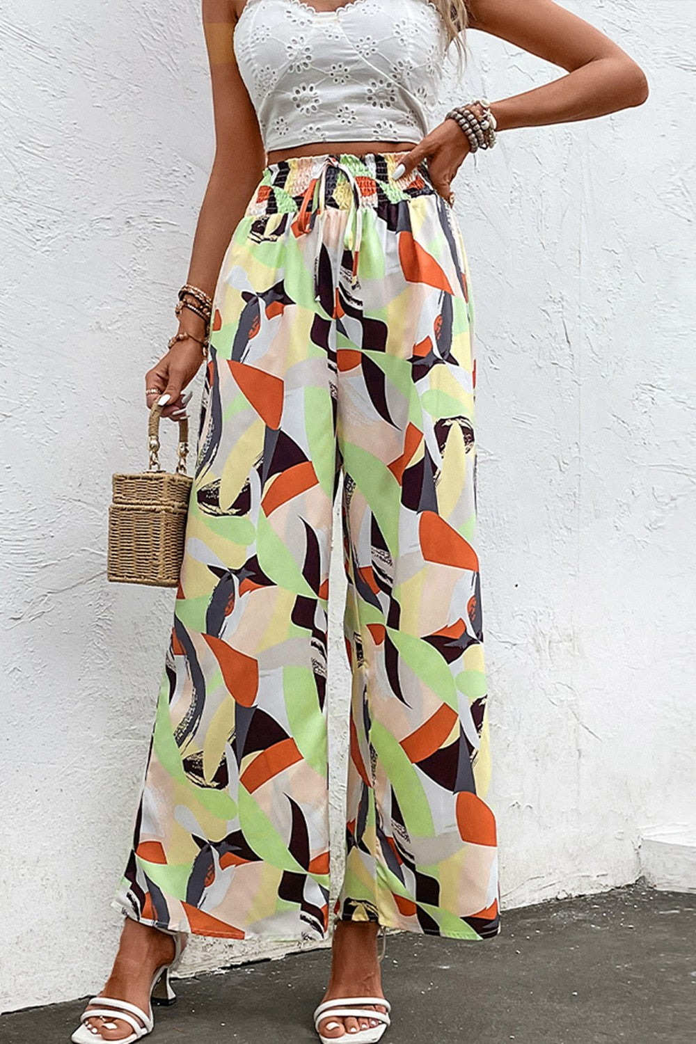 Wide-leg pants with shiny smocked waistband and multicolor abstract print