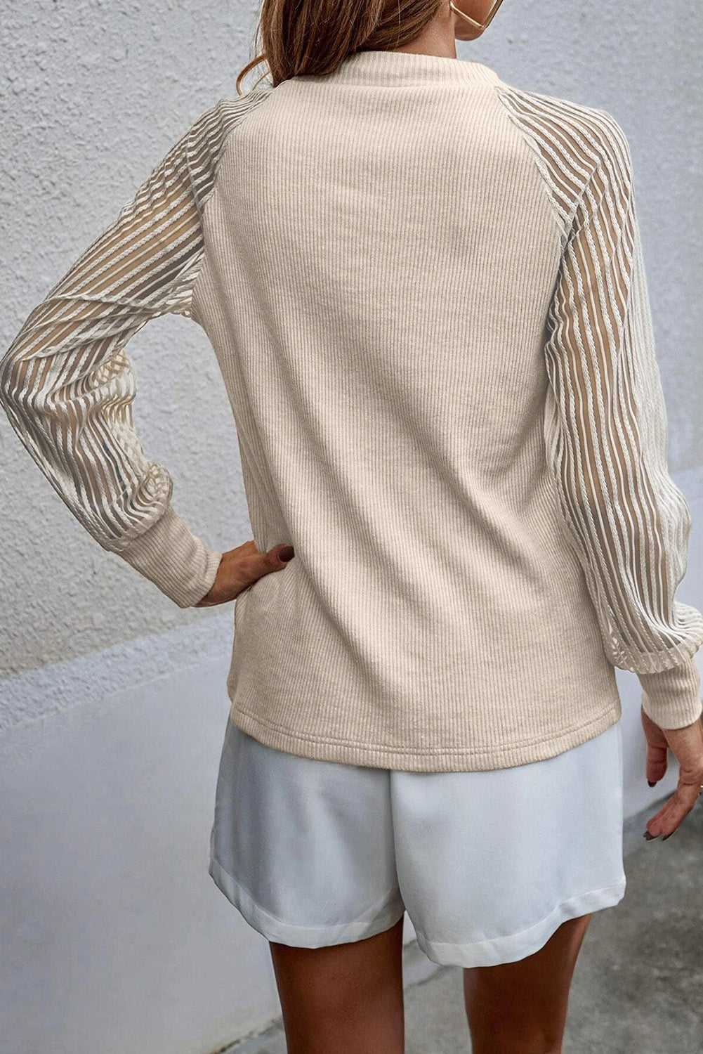 Ivory raglan knit top with round neck and vertical striped sleeves (back)