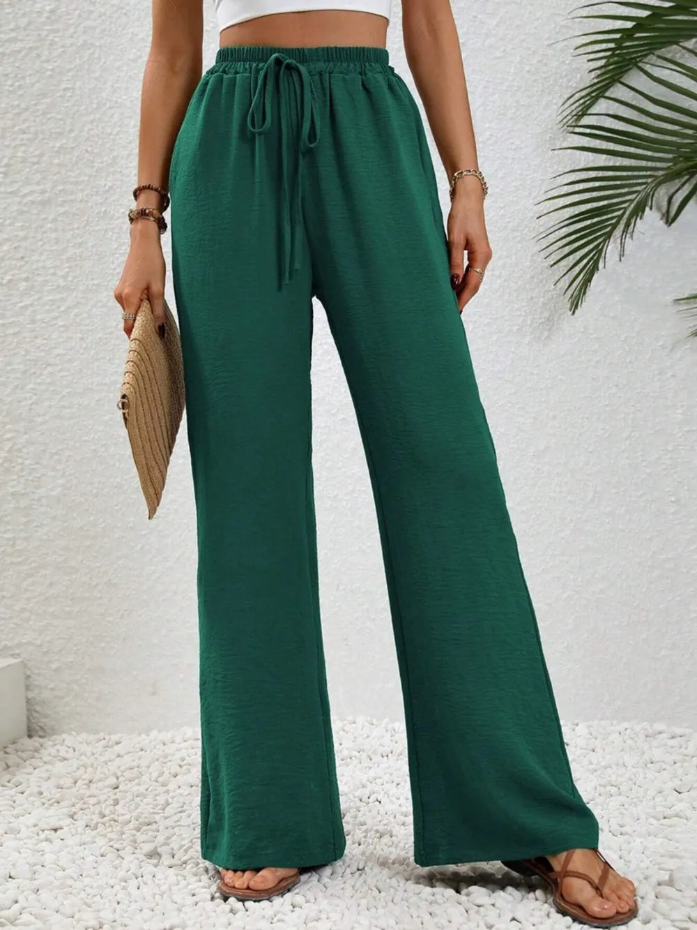 Green wide-leg drawstring pants with elastic waistband and loose wide legs