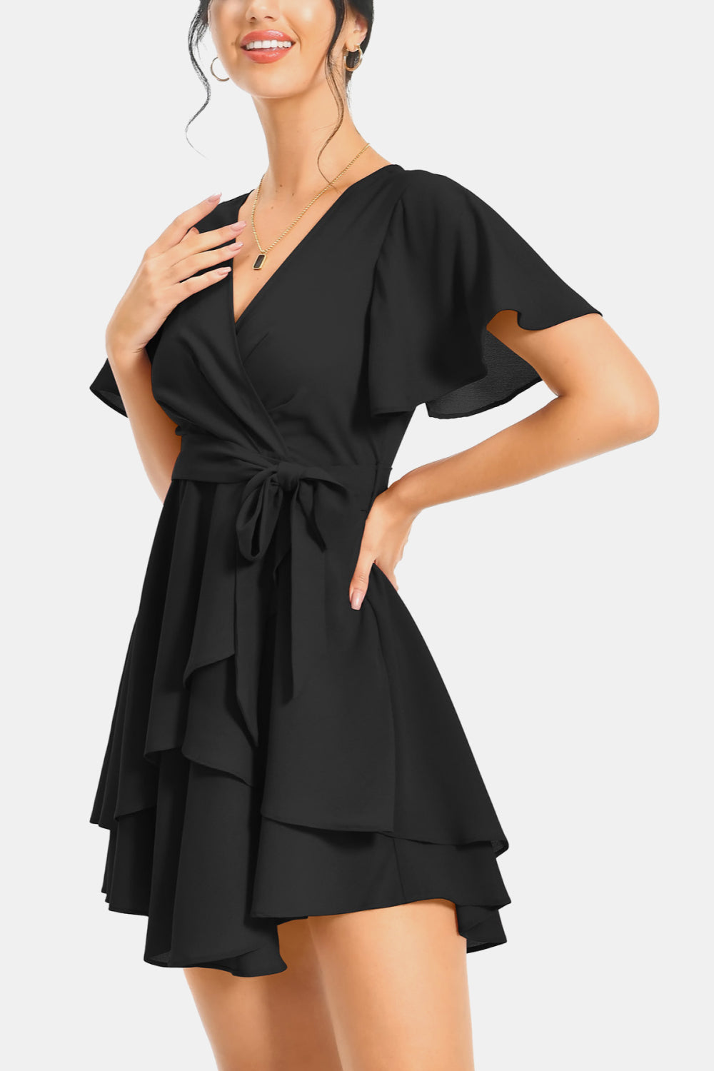 Black surplice V-neck flutter sleeve mini dress with layered ruffle skirt and tie waist