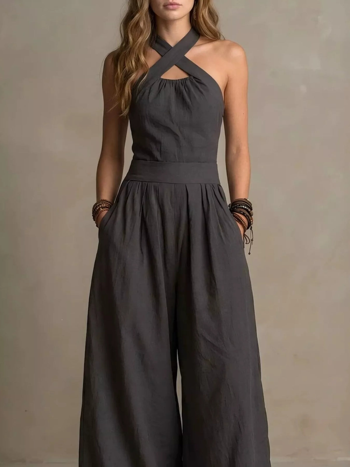 Dark gray halter linen jumpsuit with crisscross neckline and wide-leg pants