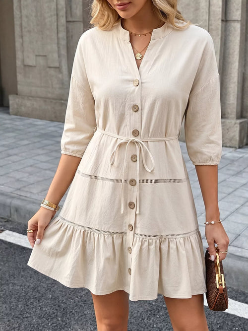 Cream button-front mini dress with tied waist belt and tiered ruffle skirt