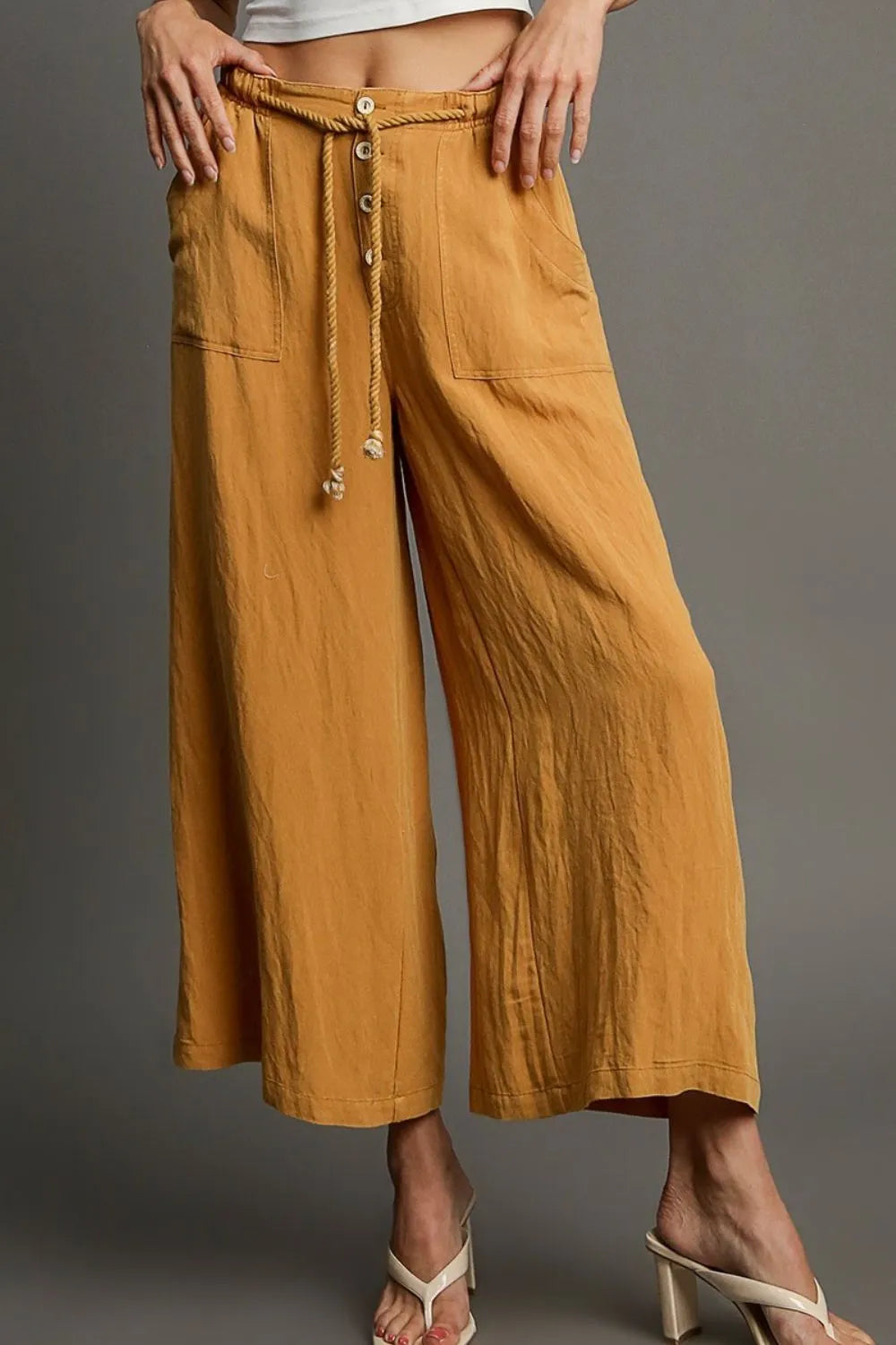Mustard wide-leg pants with drawstring rope, grommet buttons, and two pockets