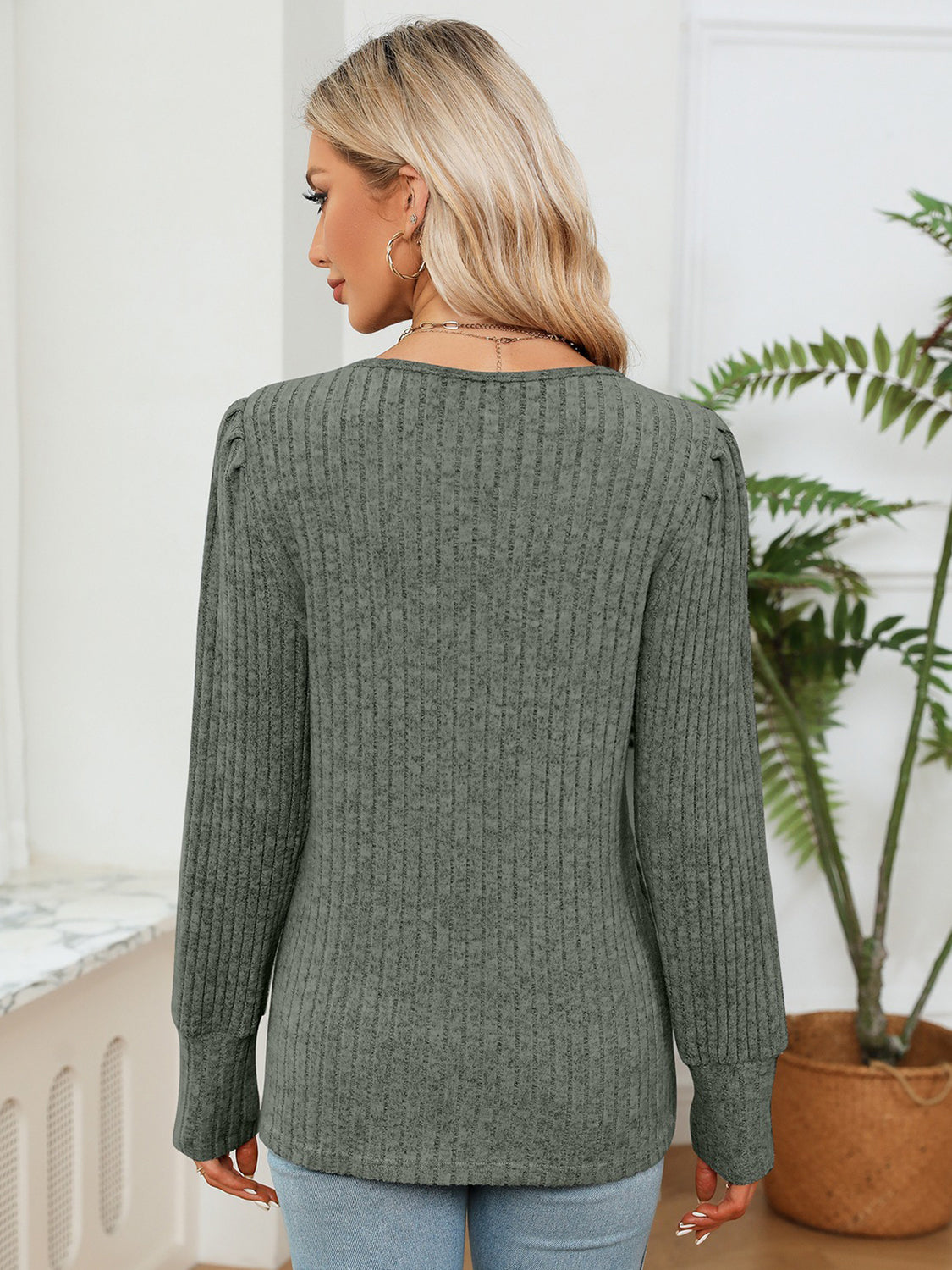 Moss green ribbed blouse back view with long sleeves and rounded hem