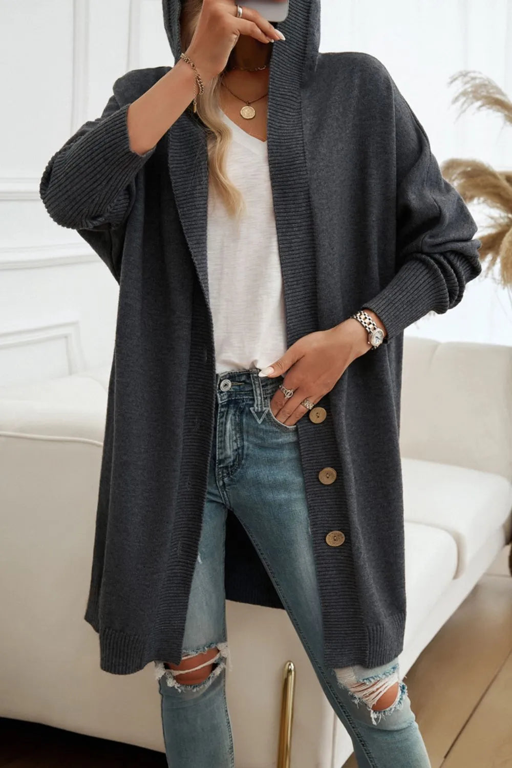 Dark gray hooded cardigan with long sleeves, open front, and button details.