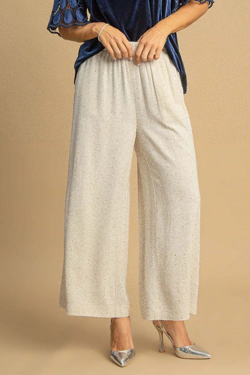 High-waisted linen pants with speckled oatmeal texture, wide-leg silhouette, elastic waist