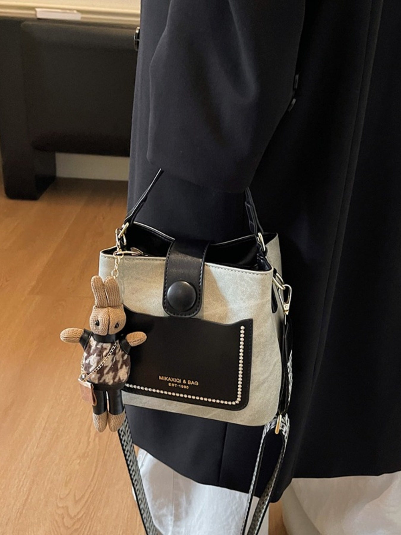 Two-Tone Bucket Crossbody Bag, small PU with beige body and black trim, front studded pocket