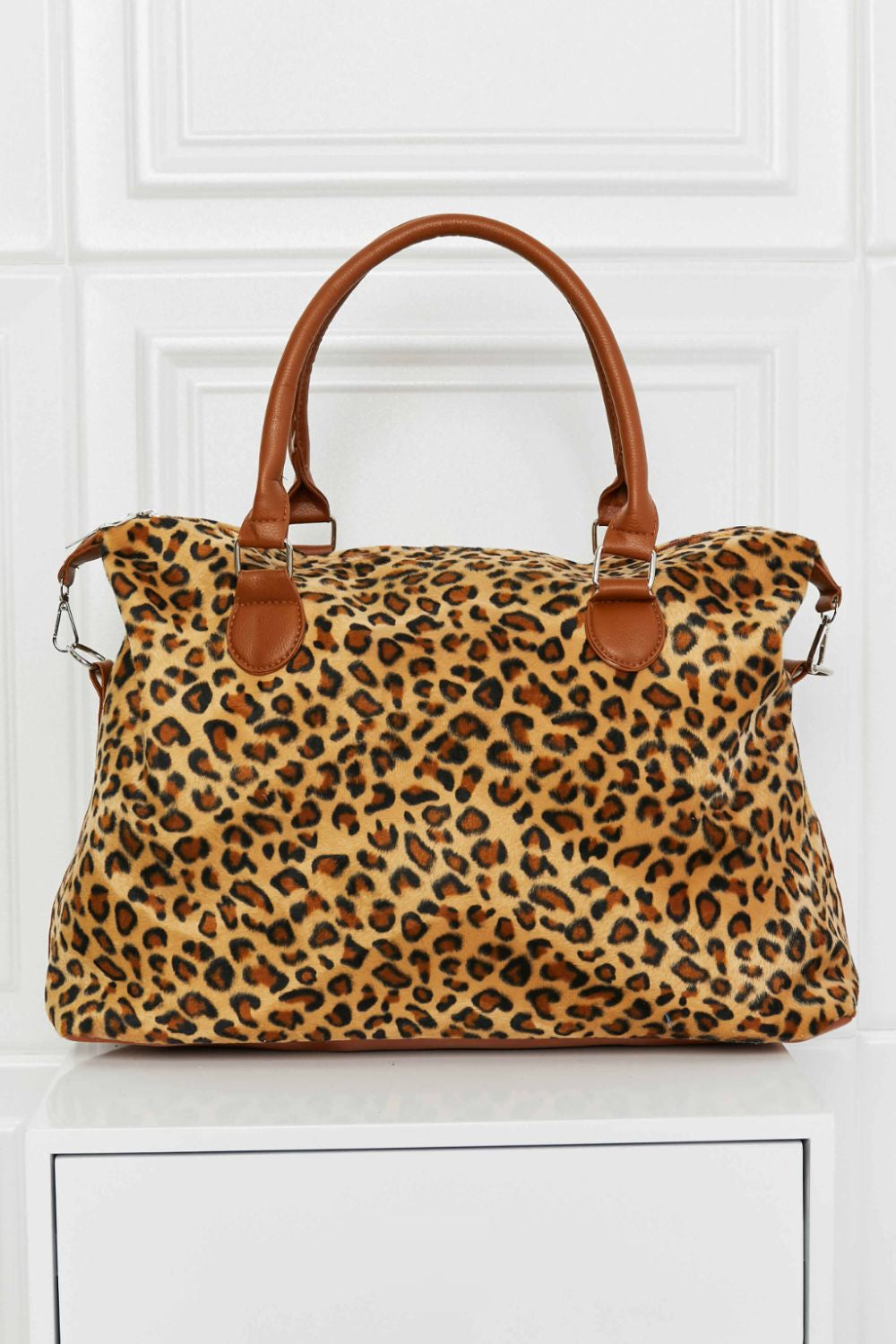 Leopard print brushed weekender bag with tan handles and zip-top closure