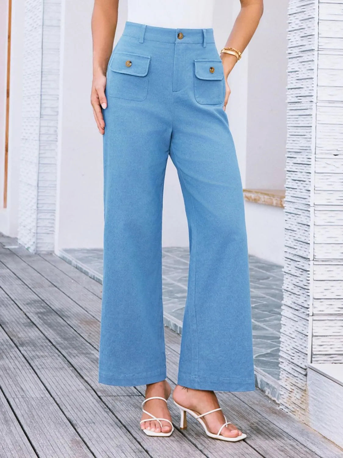 Sky blue high-waist wide-leg pants with buttoned patch pockets and relaxed wide legs