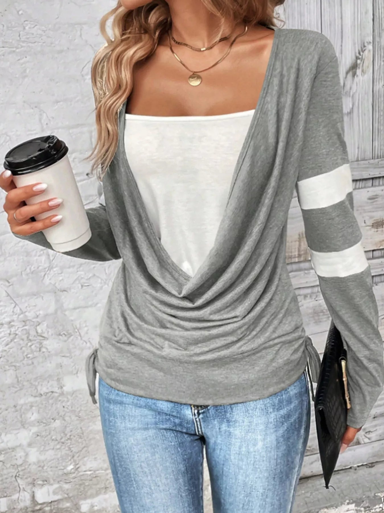 Light gray cowl-neck long-sleeve top with striped sleeve cuffs and drawstring hem
