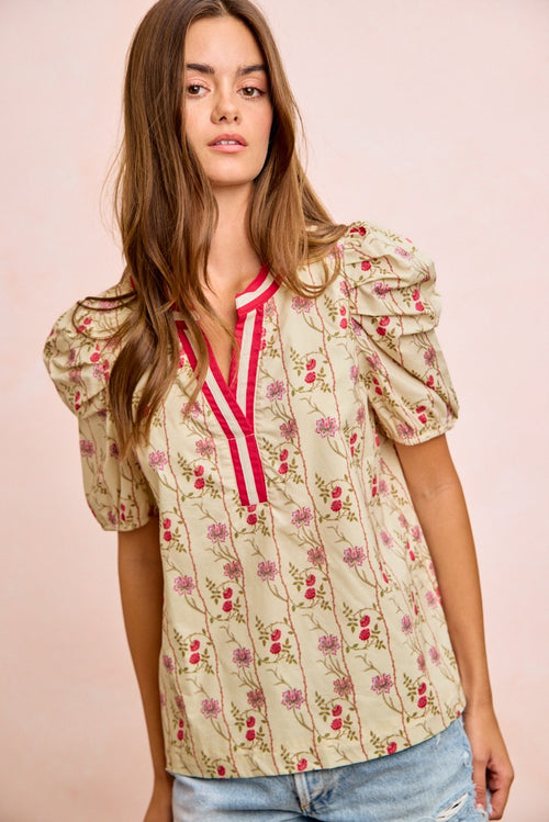 Cream floral blouse with contrast red V-neck and gathered puff sleeves