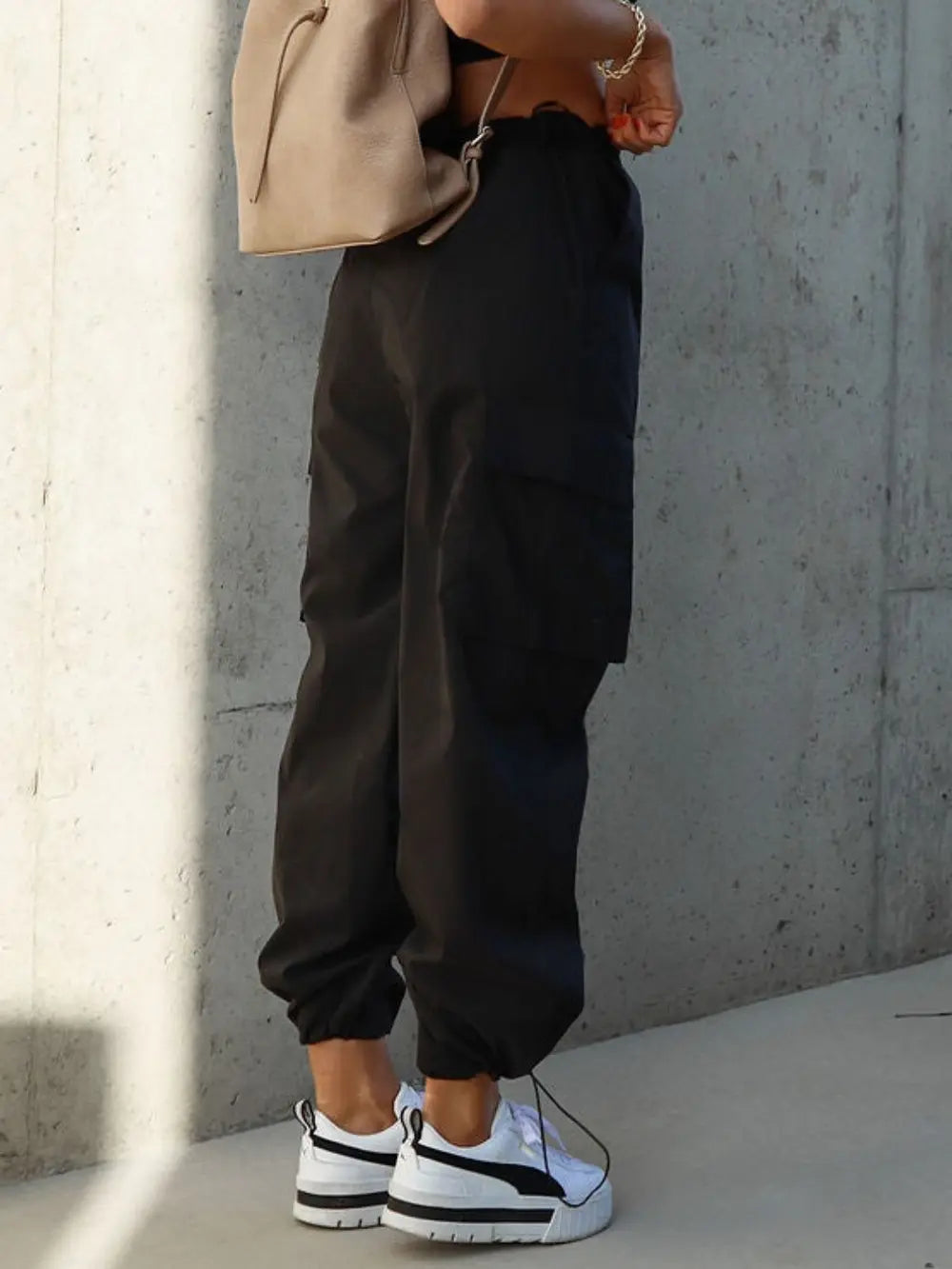 Black drawstring pants with pockets and cuffed hems