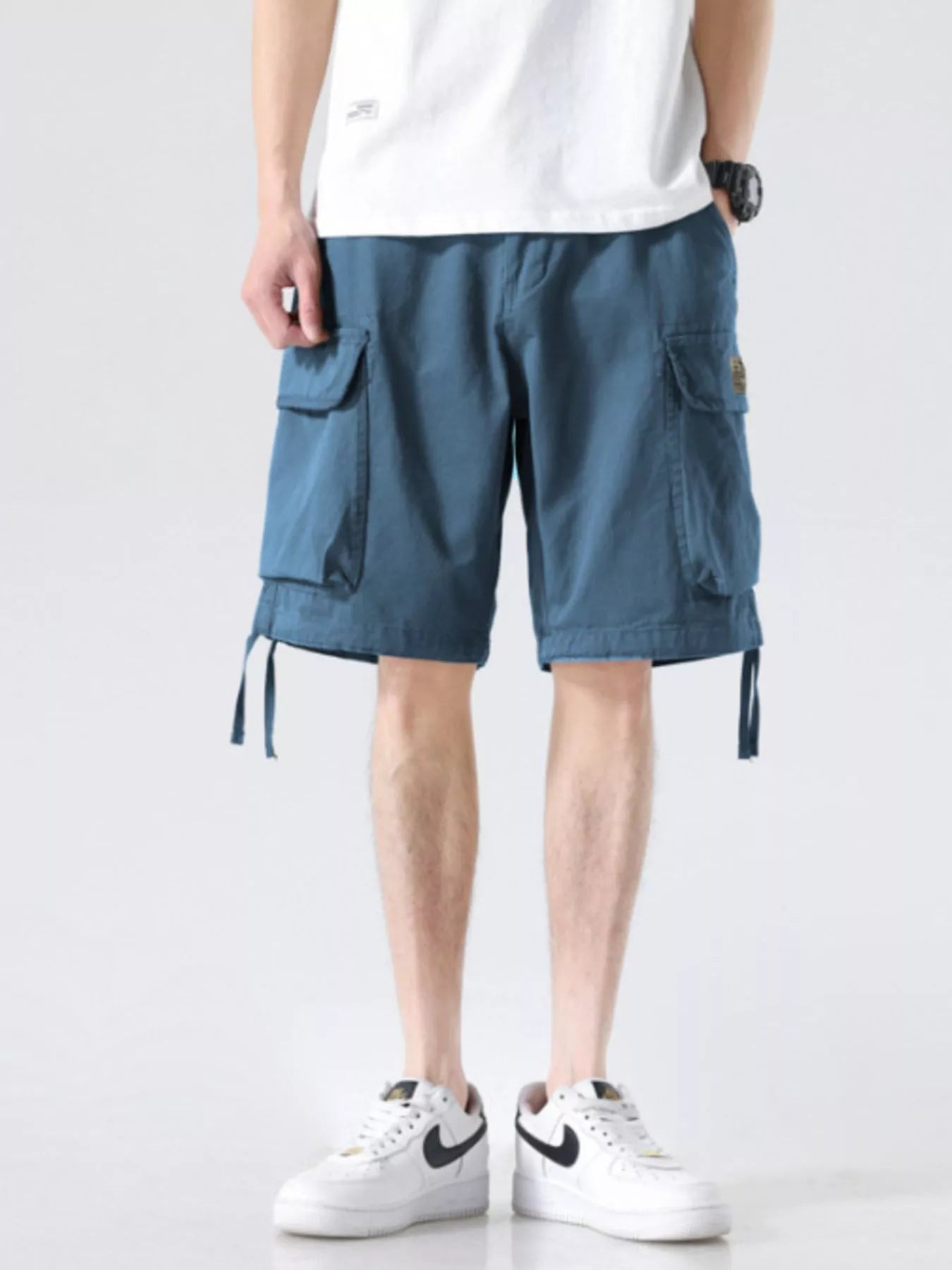 Blue cargo shorts with drawstring waist, side cargo pockets, and hanging hem ties