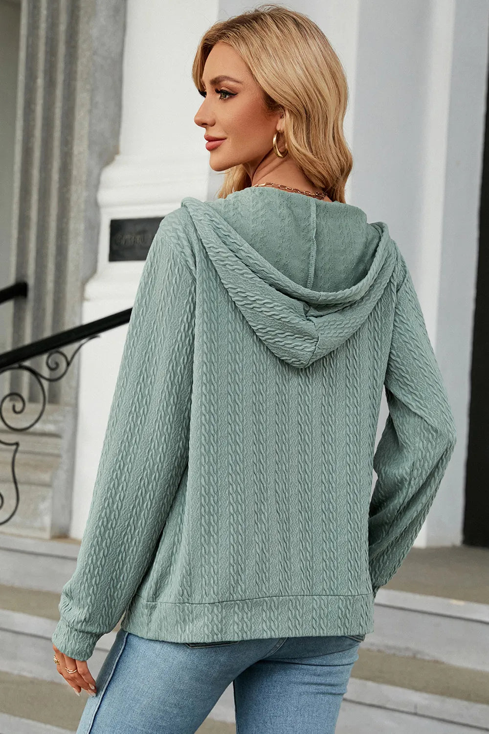 Turquoise zip-up hoodie with hood and long sleeves, drawstring hem detail