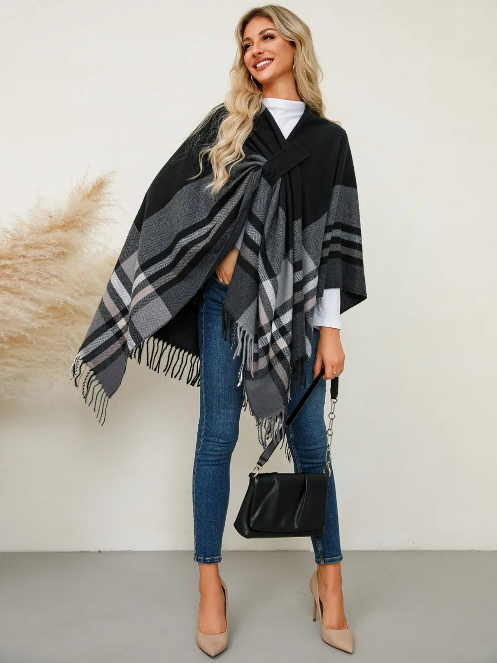 Fringe plaid poncho in black with gray check panels and draped wrap front