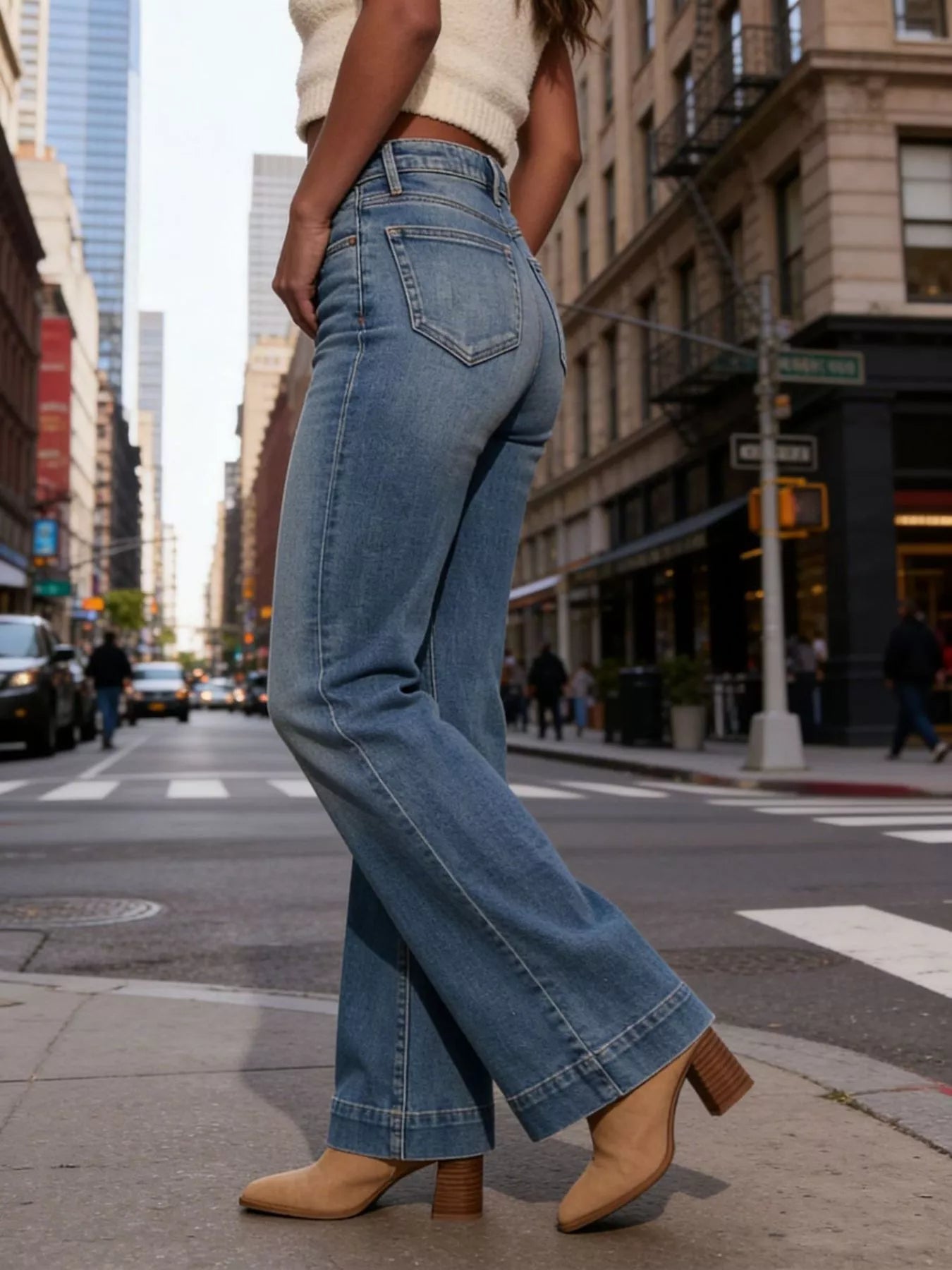 Blue high-waisted flare-leg jeans with back pocket and stitched seams on flared hem