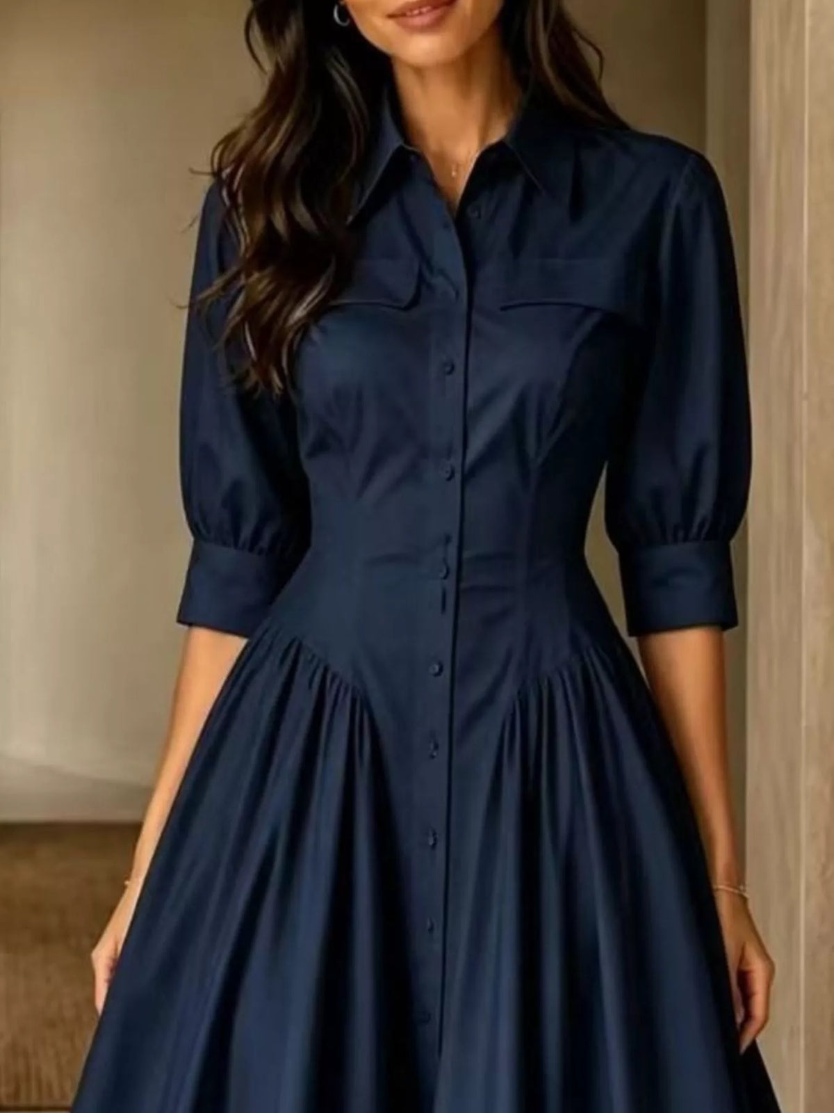 Dark navy button-down shirt dress with cinched waist, 3/4 puff sleeves, and button front.