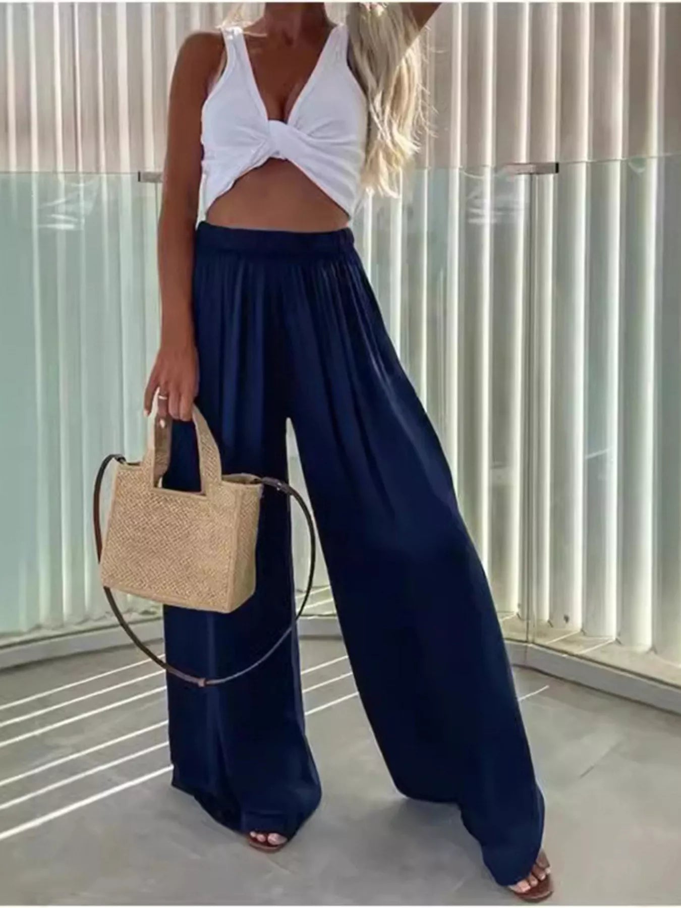 Deep blue wide-leg flowy pants with gathered waist and flowing pleated silhouette