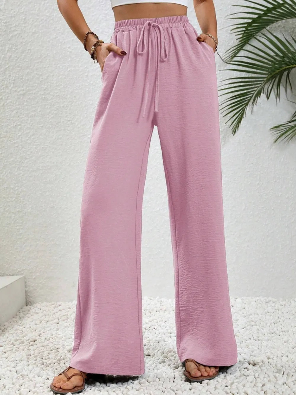 Pink wide-leg drawstring pants with elastic waist and loose flowy fit