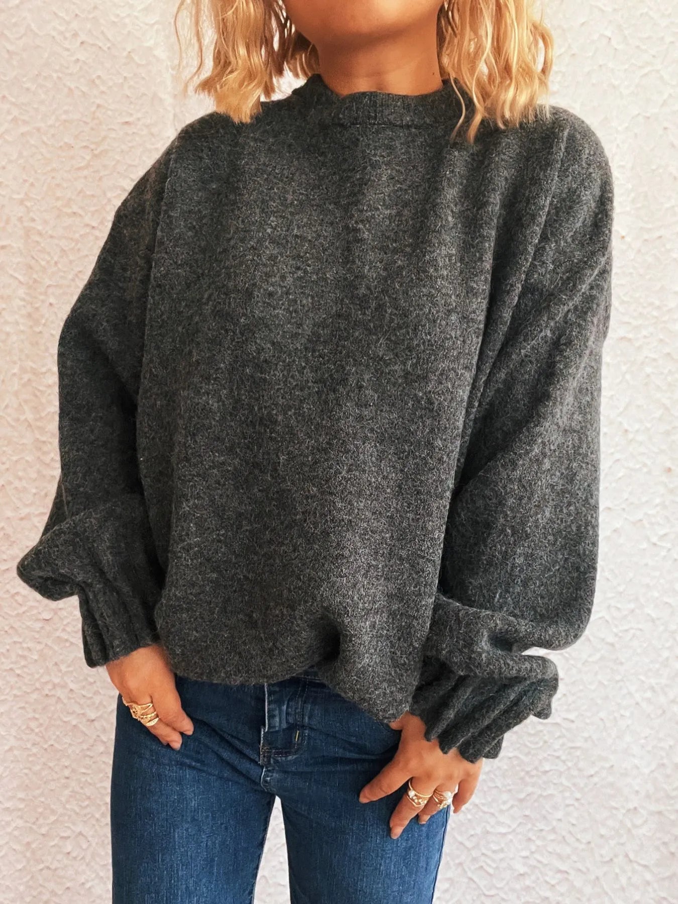 Dark gray round-neck sweater with relaxed dropped shoulders and cuffed sleeves