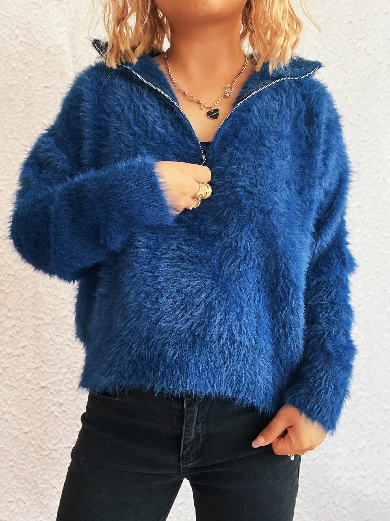 Blue fuzzy half-zip sweater with front zipper detail and long sleeves