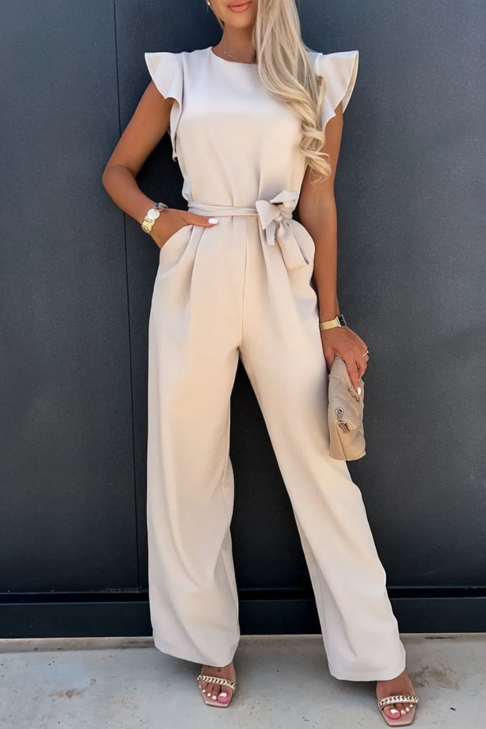 Tan round-neck cap-sleeve jumpsuit with waist tie and wide-leg pants