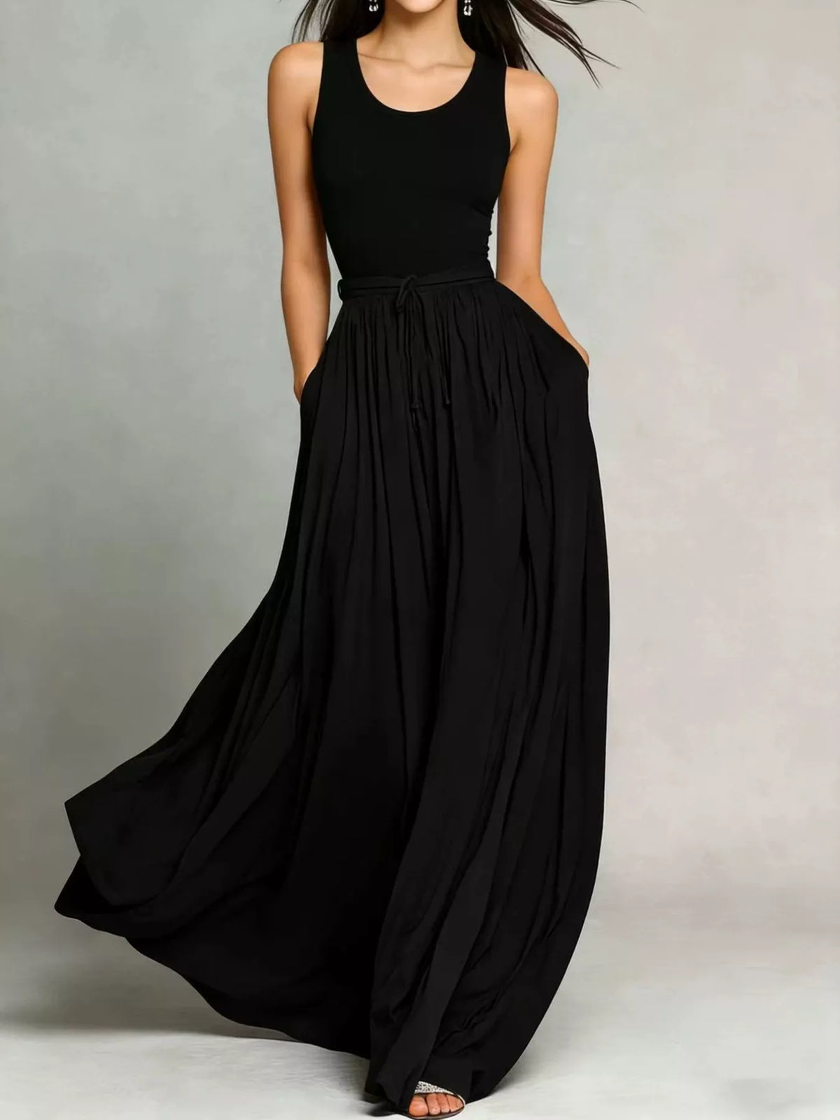 Black sleeveless maxi dress with drawstring waist and billowy gathered skirt