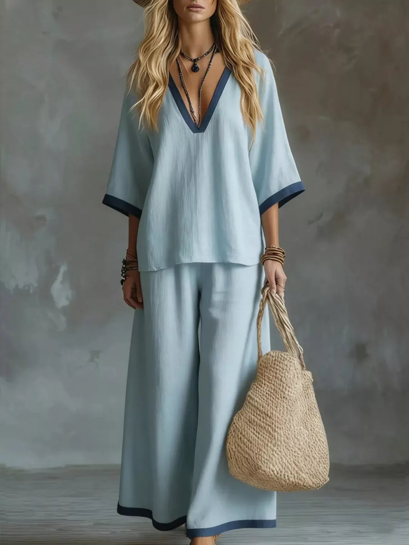Light blue V-neck top and wide-leg pants set with navy contrast trim and side pockets.