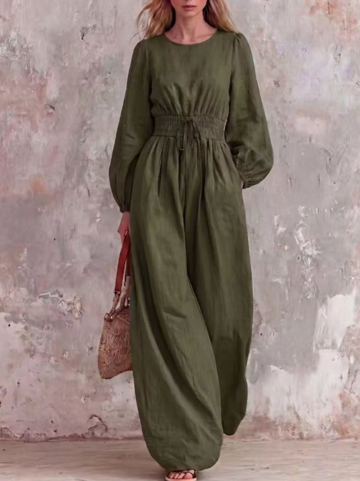 Smocked waist long-sleeve jumpsuit in army green with gathered waist and wide legs