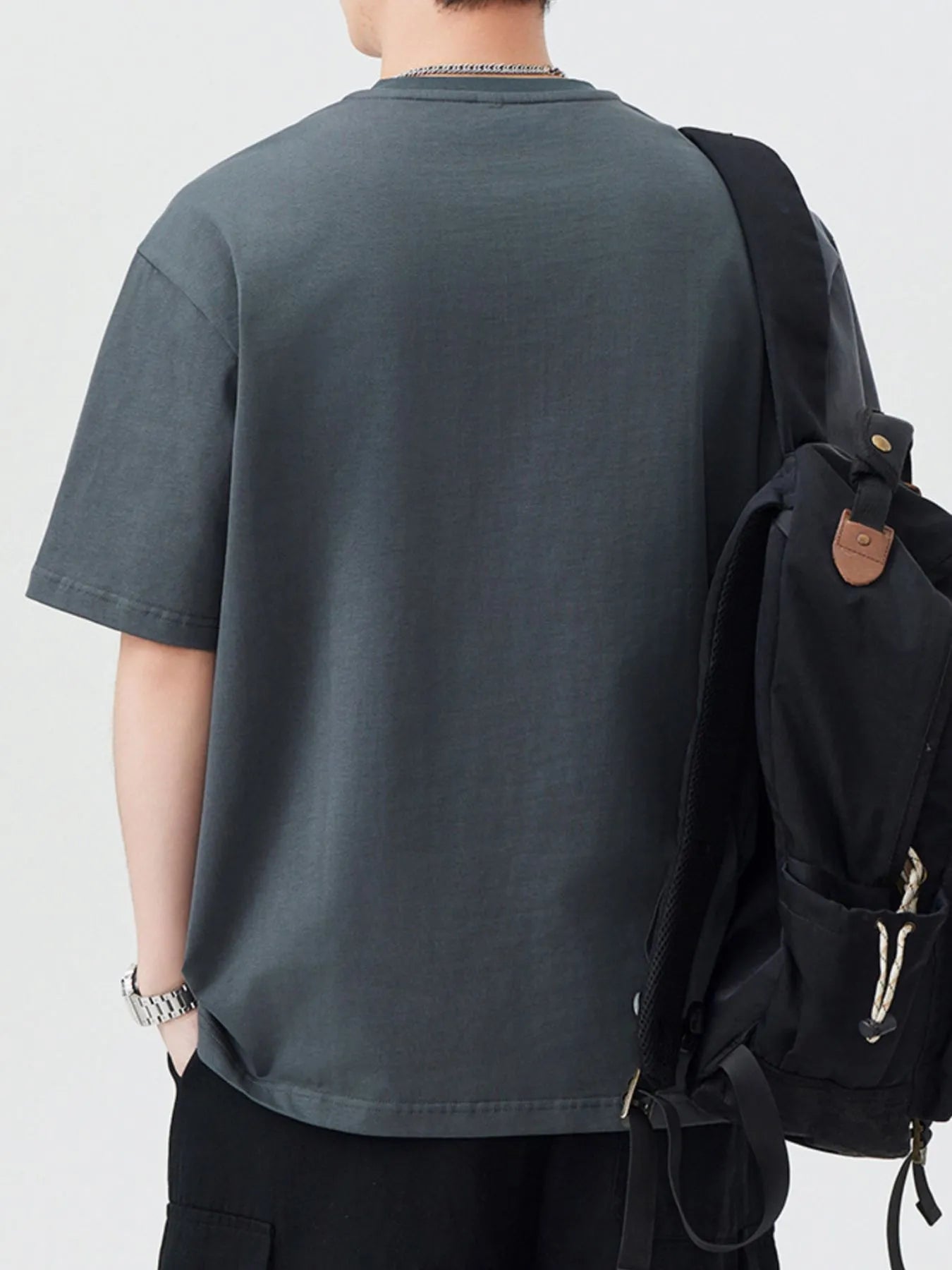Dark gray oversized half-zip T-shirt, back view with short sleeves and zipper