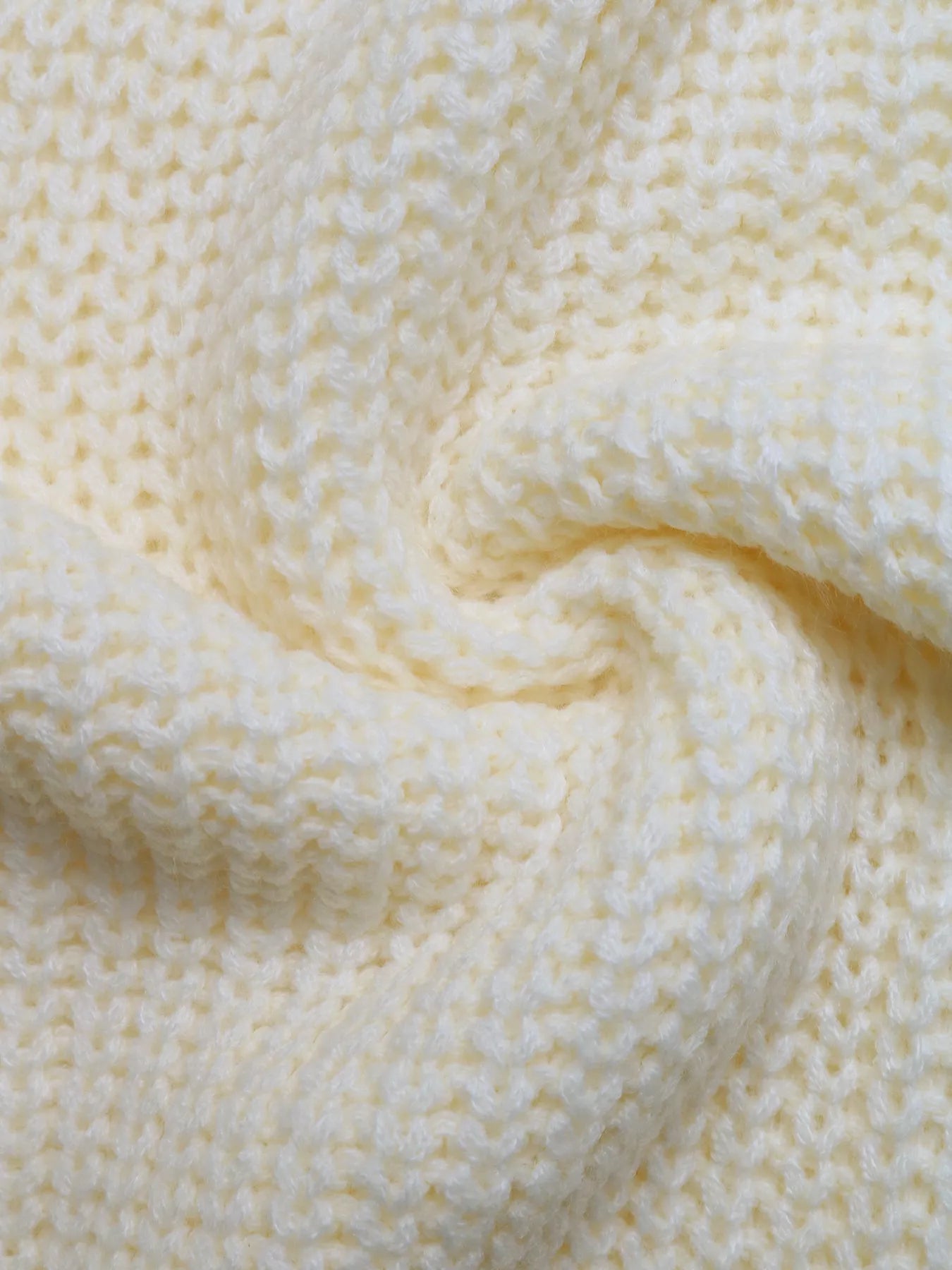 Ivory knitted sweater fabric with textured stitch pattern